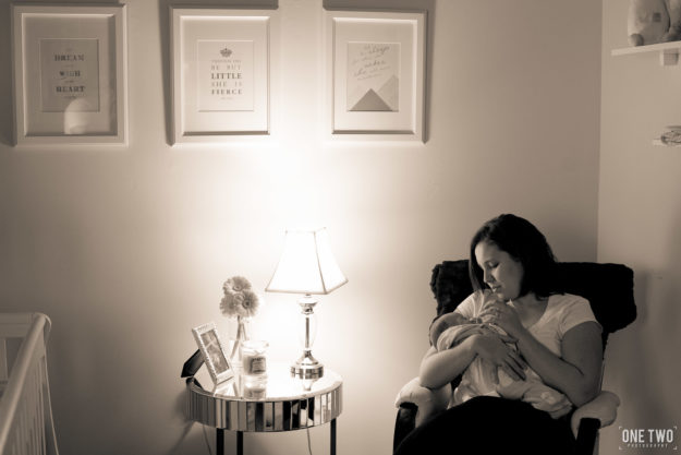 mother nursing baby rocking chair nursery newborn photography