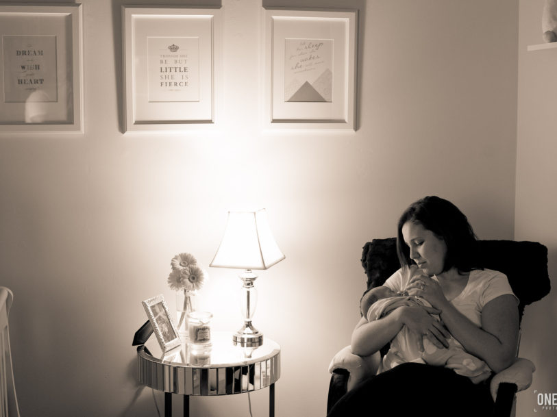 mother nursing baby rocking chair nursery newborn photography