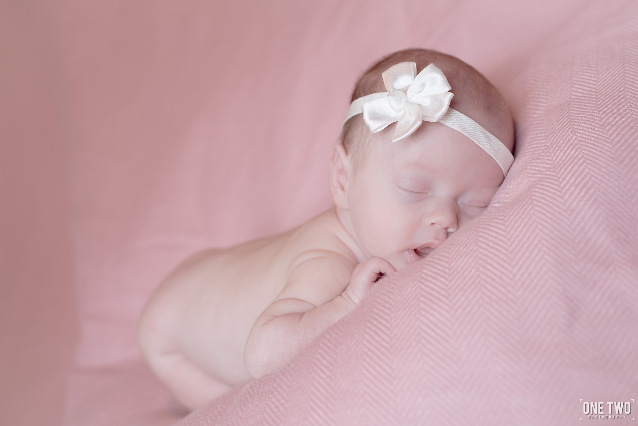 baby girl in pink newborn photography